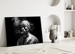 Tupac glass wall art styled above a console in a media room