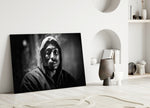 Tupac glass wall art styled above a console in a media room