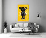 Kaws glass wall art styled above a sideboard in a powder room