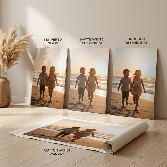 Custom wall art shown on all four materials side by side: tempered glass, matte white aluminium, brushed aluminium and rolled cotton canvas
