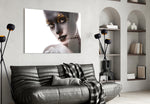 Female Portrait 34 glass wall art styled above a bed in a metallic-accent bedroom