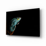 Chameleon glass wall art displayed above a console in a designer interior