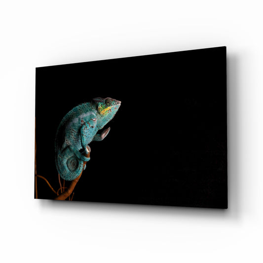Chameleon glass wall art displayed above a console in a designer interior