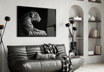 Leopard glass wall art styled above a sofa in a safari-lounge living room