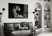Leopard glass wall art styled above a sofa in a safari-lounge living room