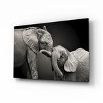 Elephants glass wall art displayed above a console in a designer interior