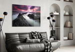 Sunset Landscape glass wall art styled above a sofa in a cinematic living room