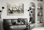 Running Horses glass wall art styled above a sofa in an adventurous living room
