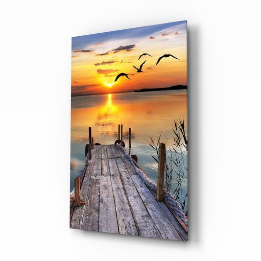 Sunset on the Dock glass wall art displayed above a console in a designer interior