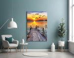 Sunset on the Dock glass wall art styled above a bed in a lake-house bedroom