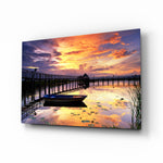 Sunset on the Dock glass wall art displayed above a console in a designer interior