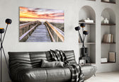 Sunset on the Dock glass wall art styled above a sofa in a seaside-mood living room