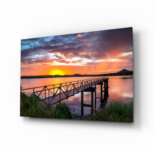 Sunset on the Beach glass wall art displayed above a console in a designer interior