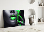 Close-up detail of neon green paint dripping from lips and fingertips