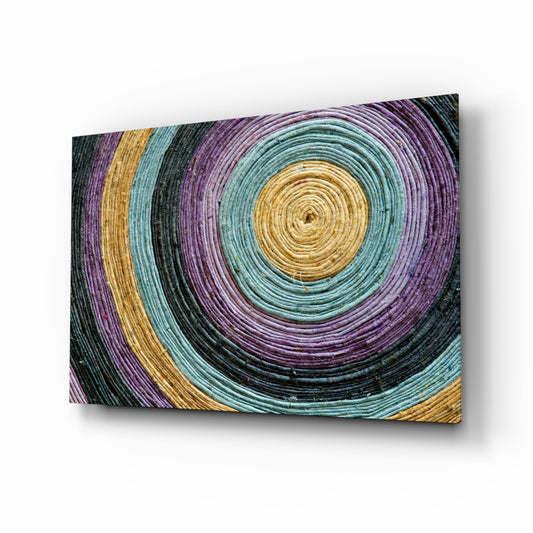 Colored Spiral glass wall art displayed above a console in a designer interior