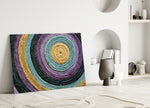 Close-up detail of violet, teal and mustard concentric paper-cord rings