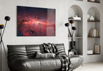 Red Nebula glass wall art styled above a desk in an imaginative study