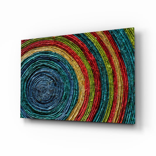 Colored Spiral glass wall art displayed above a console in a designer interior