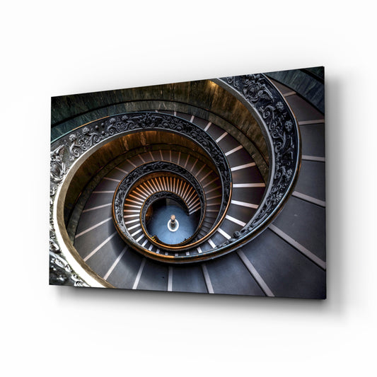 Spiral glass wall art displayed above a console in a designer interior