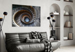 Spiral glass wall art styled above a desk in a travel-memory study