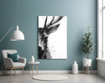 Deer glass wall art styled above a bed in a serene bedroom