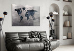World Map glass wall art styled above a desk in a travel-mood study