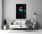 Close-up detail of crimson apple submerged in glossy turquoise paint