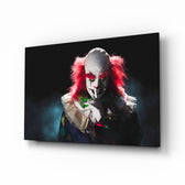 Clown glass wall art displayed above a console in a designer interior