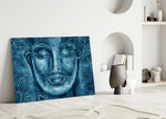 Close-up detail of cobalt Buddha face with floral filigree background