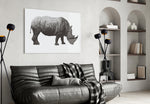 Rhino glass wall art styled above a desk in an editorial study
