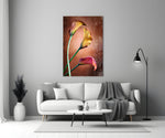 Close-up detail of golden-yellow and ruby calla blooms on copper bronze