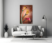Close-up detail of golden-yellow and ruby calla blooms on copper bronze