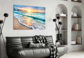 Sunset glass wall art styled above a console in a beach house