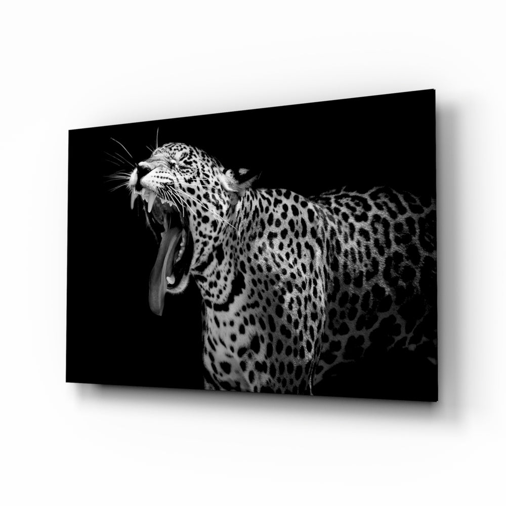 Leopard glass wall art displayed above a console in a designer interior