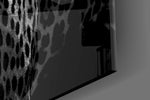 Leopard artwork anchoring a library with moody palette