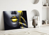 Close-up detail of molten yellow streaming from charcoal lips