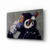 Thinking Monkey glass wall art displayed above a console in a designer interior
