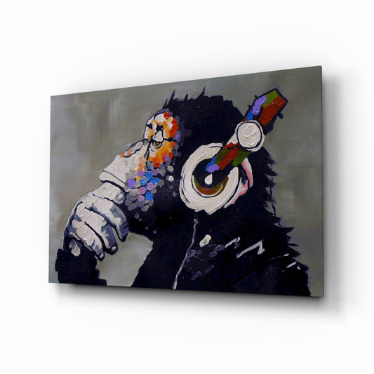 Thinking Monkey glass wall art displayed above a console in a designer interior