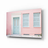 Pink House glass wall art displayed above a console in a designer interior