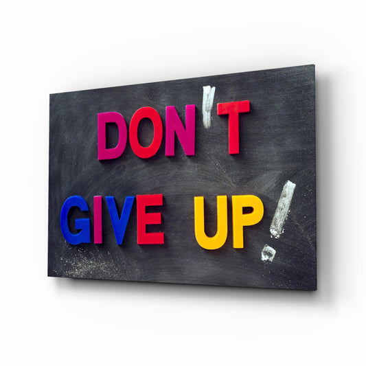 Don't Give Up glass wall art displayed above a console in a designer interior