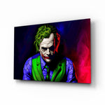 Joker glass wall art displayed above a console in a designer interior