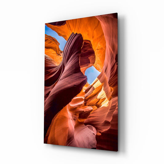 Canyon glass wall art displayed above a console in a designer interior