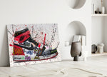 Close-up detail of scarlet swoosh and spray-paint slogans