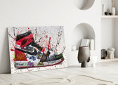 Close-up detail of scarlet swoosh and spray-paint slogans