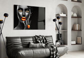 The Power of Orange glass wall art styled above a vanity in a powder room