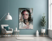 Women's glass wall art styled above a desk in a reflective study