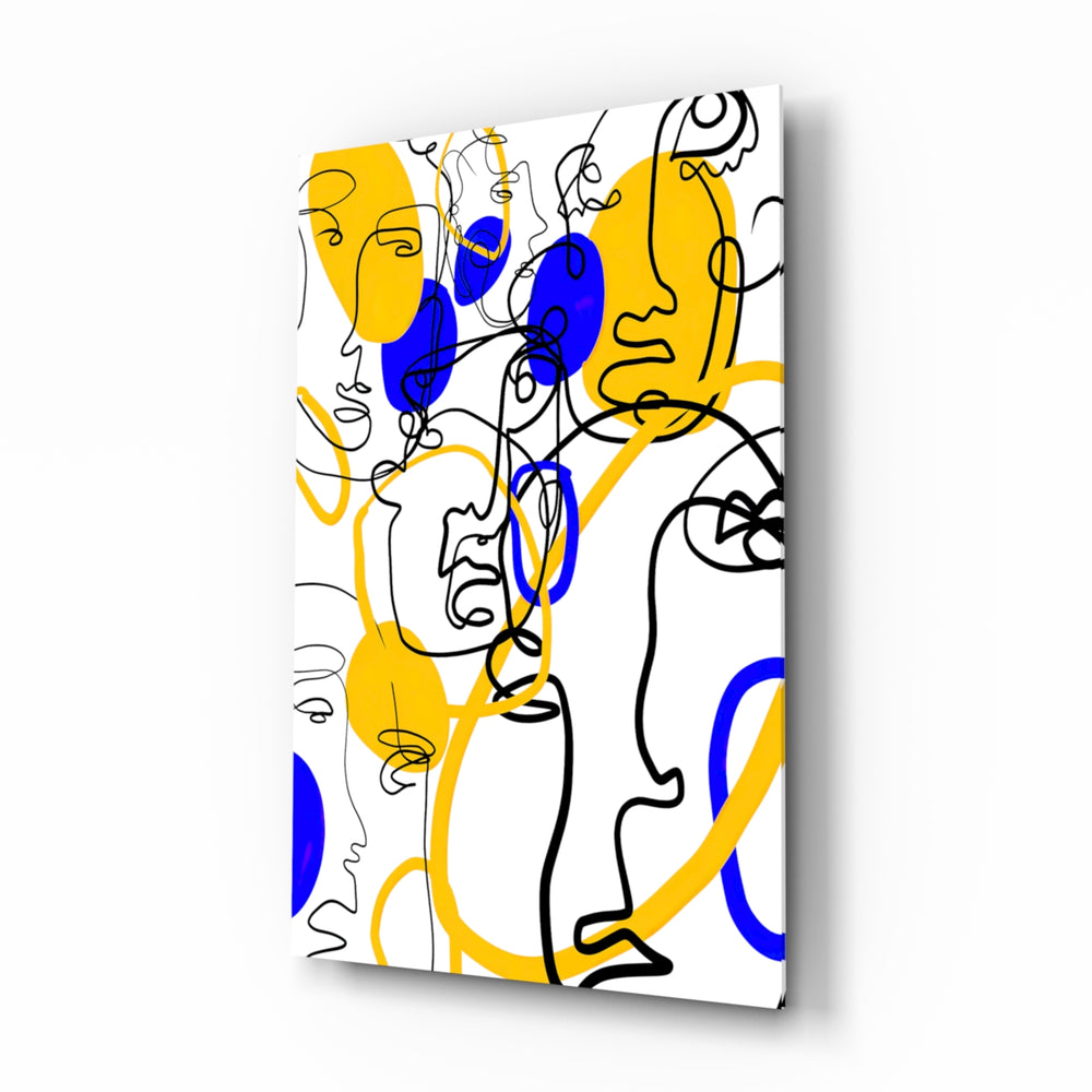 Abstract Faces glass wall art displayed above a console in a designer interior