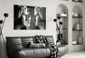 Three Muses glass wall art styled above a desk in a study