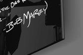 Words of Bob Marley glass wall art catching light to reveal its painted lettering