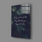 Close-up detail of palm fronds with handwritten quote behind glass